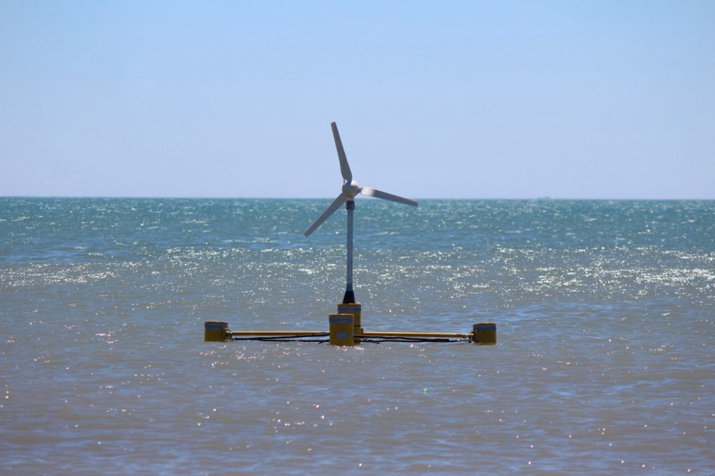 Small floating wind turbine model on a yellow pontoon